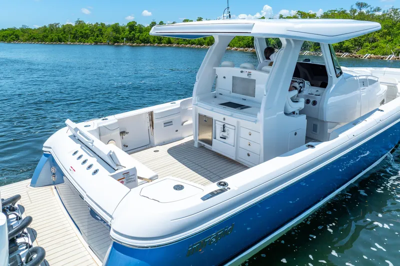 Slide: The Image of 2025 Intrepid 41 Panacea boat on water, featuring sleek design and spacious deck. - 8