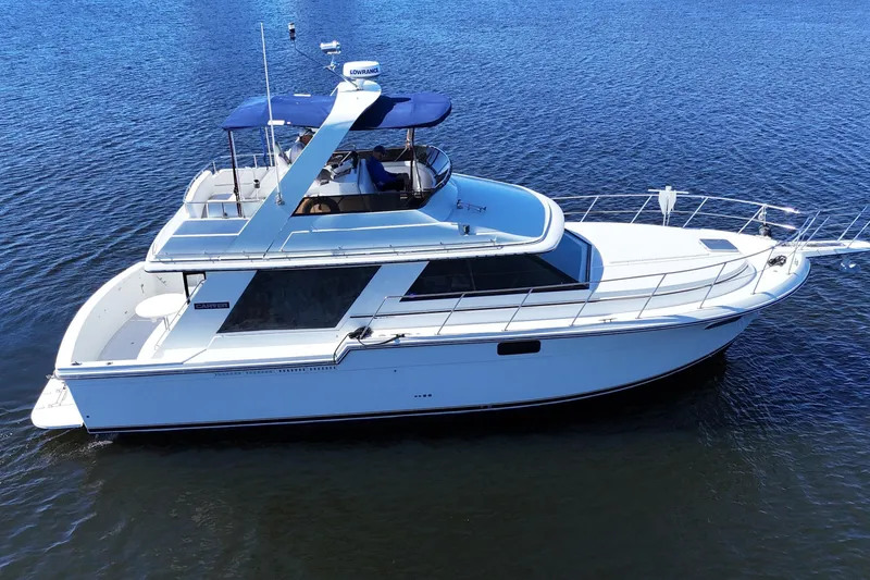 Slide: The Image of 1987 Carver 4227 Cockpit Motor Yacht on calm water, side view. - 1