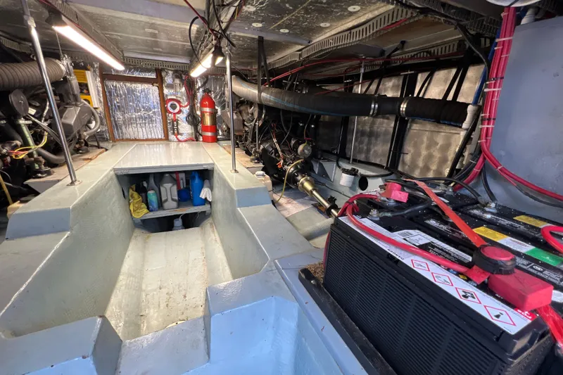 Slide: The Image of Engine room of 1987 Carver 4227 Cockpit Motor Yacht with battery and equipment. - 102