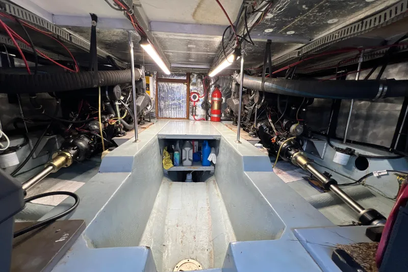 Slide: The Image of Engine room of 1987 Carver 4227 Cockpit Motor Yacht, showcasing mechanical components and storage. - 103