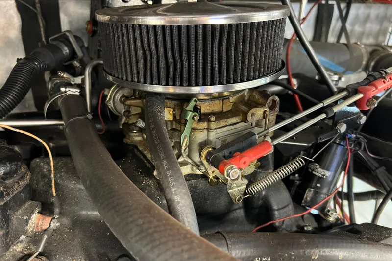 Slide: The Image of Engine components of a 1987 Carver 4227 Cockpit Motor Yacht, featuring air filter and hoses. - 110