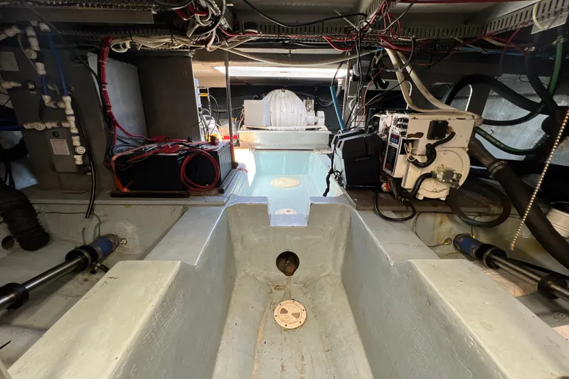 Slide: The Image of Engine room of 1987 Carver 4227 Cockpit Motor Yacht, showcasing wiring and mechanical components. - 113