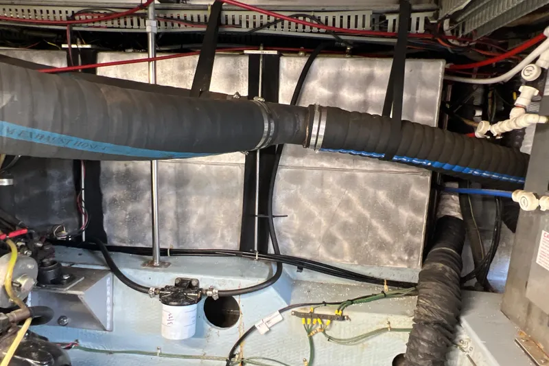 Slide: The Image of Engine room of 1987 Carver 4227 Cockpit Motor Yacht with hoses and wiring. - 116