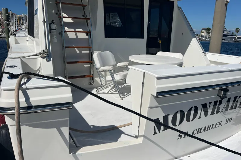 Slide: The Image of 1987 Carver 4227 Cockpit Motor Yacht with seating area, docked in sunny marina. - 14