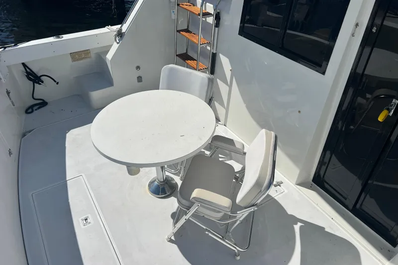 Slide: The Image of 1987 Carver 4227 Cockpit Motor Yacht with table and chairs on deck. - 17