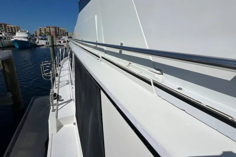 Slide: The Image of 1987 Carver 4227 Cockpit Motor Yacht docked at marina, side view. - 21