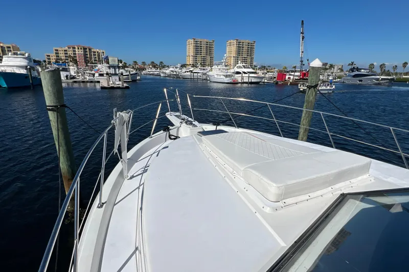 Slide: The Image of 1987 Carver 4227 Cockpit Motor Yacht docked in a marina, surrounded by other boats. - 23