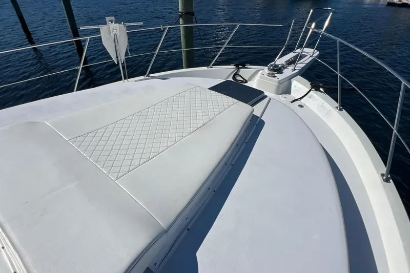 Slide: The Image of 1987 Carver 4227 Cockpit Motor Yacht deck with cushioned seating and railing. - 24