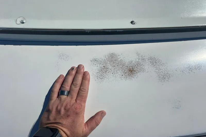 Slide: The Image of Hand inspecting surface rust on 1987 Carver 4227 Cockpit Motor Yacht. - 29