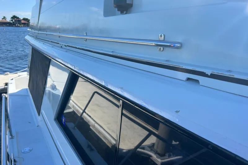 Slide: The Image of 1987 Carver 4227 Cockpit Motor Yacht side view with railing and windows. - 30