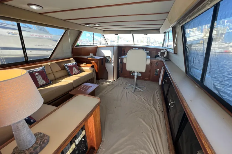 Slide: The Image of Interior of 1987 Carver 4227 Cockpit Motor Yacht with seating and helm station. - 34