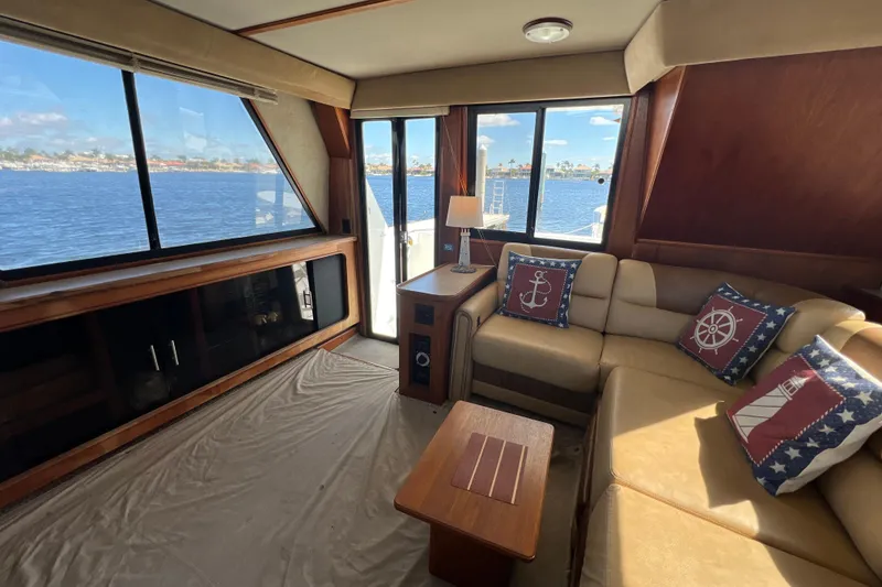 Slide: The Image of Interior of 1987 Carver 4227 Cockpit Motor Yacht with nautical-themed decor and waterfront view. - 37