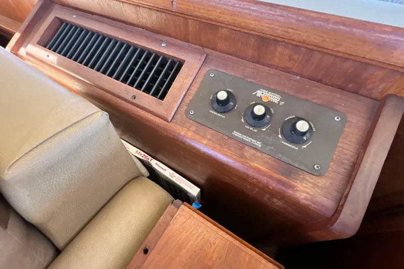 Slide: The Image of Control panel on 1987 Carver 4227 Cockpit Motor Yacht with wooden finish and air system controls. - 44