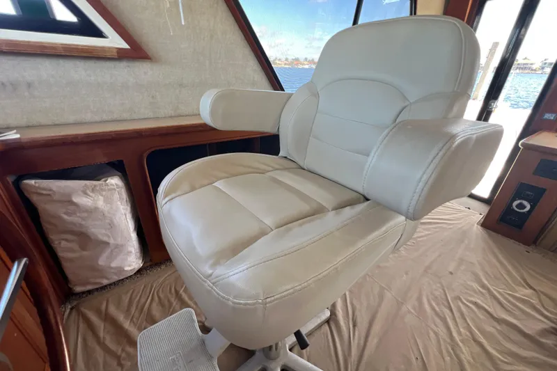 Slide: The Image of Captain's chair in 1987 Carver 4227 Cockpit Motor Yacht interior, with window view. - 47
