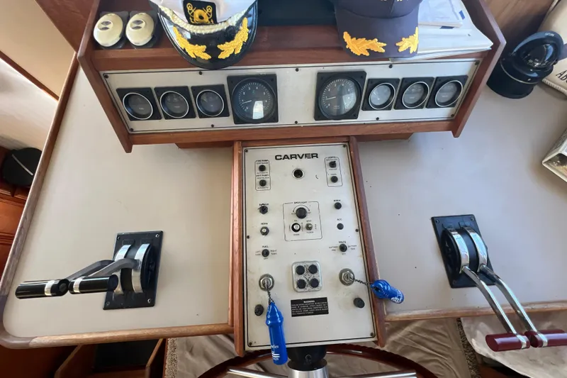 Slide: The Image of Control panel of a 1987 Carver 4227 Cockpit Motor Yacht with gauges and levers. - 52