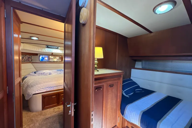 Slide: The Image of Interior of 1987 Carver 4227 Cockpit Motor Yacht with cozy bedrooms and wooden furnishings. - 60
