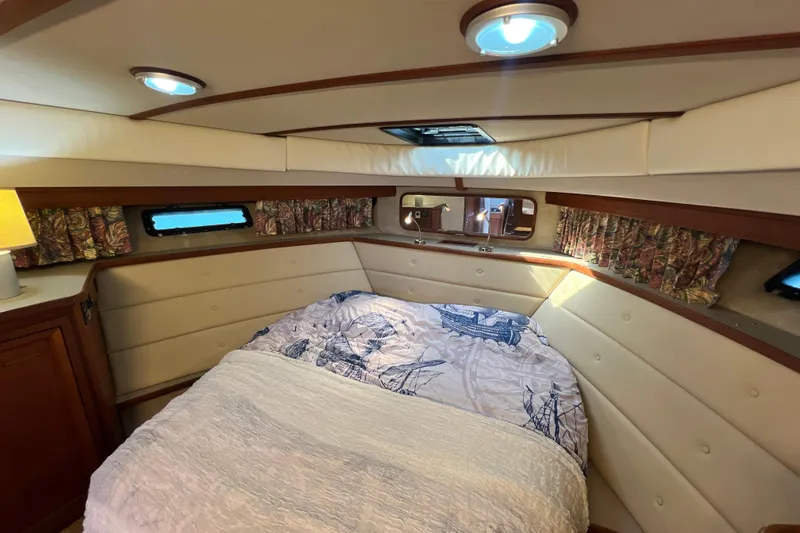 Slide: The Image of Interior of 1987 Carver 4227 Cockpit Motor Yacht with cozy bed and nautical decor. - 66