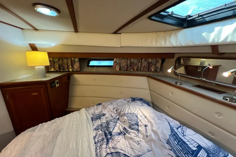Slide: The Image of Cozy bedroom in 1987 Carver 4227 Cockpit Motor Yacht with nautical-themed bedding. - 68