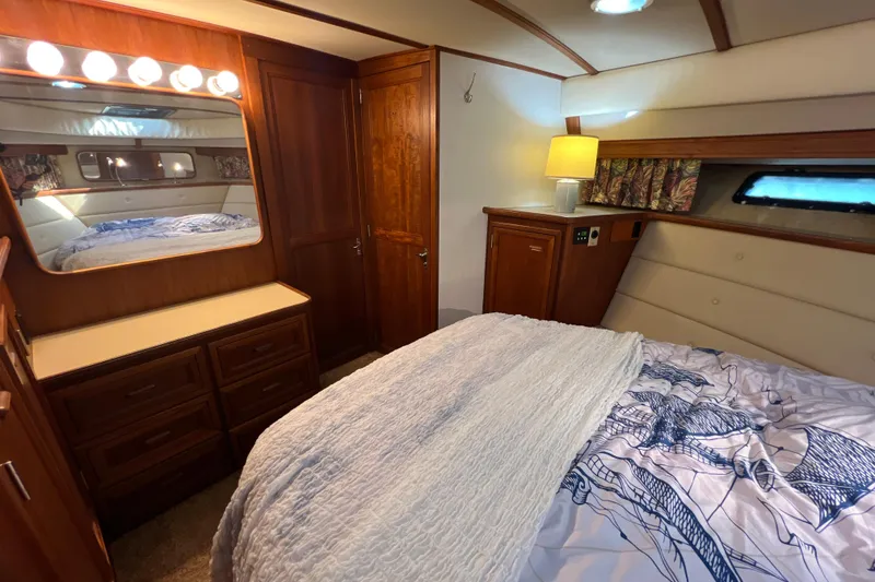 Slide: The Image of Luxurious bedroom interior of 1987 Carver 4227 Cockpit Motor Yacht with wood accents. - 69