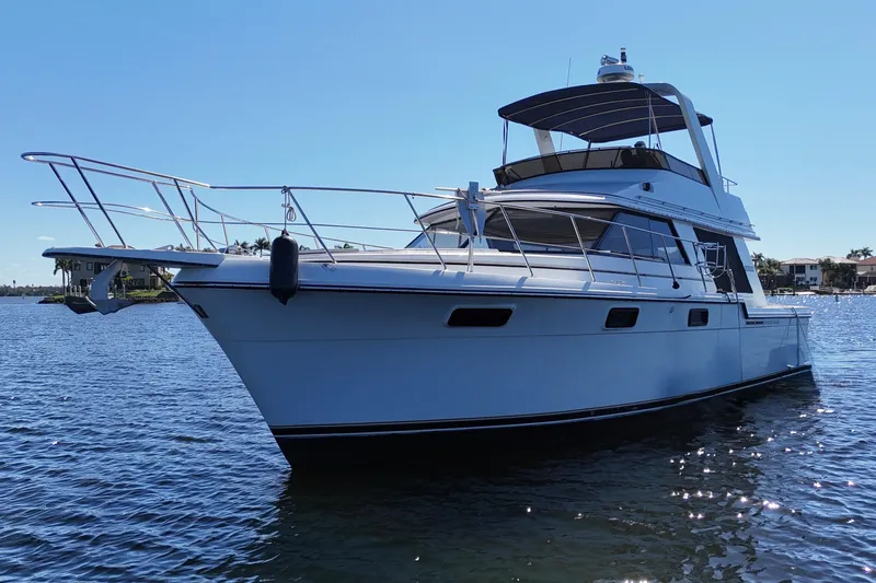 Slide: The Image of 1987 Carver 4227 Cockpit Motor Yacht on calm water, sunny day. - 7