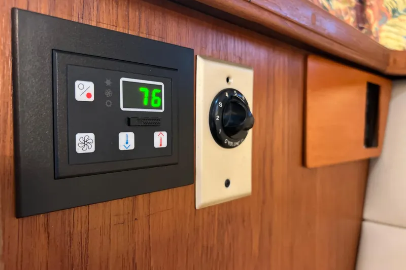 Slide: The Image of Control panel on 1987 Carver 4227 Cockpit Motor Yacht, displaying temperature and settings. - 71