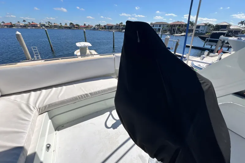 Slide: The Image of 1987 Carver 4227 Cockpit Motor Yacht with waterfront view and covered seating area. - 78