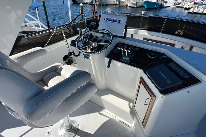 Slide: The Image of Cockpit of 1987 Carver 4227 Motor Yacht with steering wheel and navigation equipment. - 80