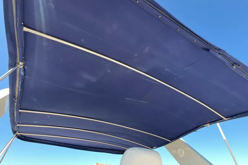 Slide: The Image of Blue canopy of 1987 Carver 4227 Cockpit Motor Yacht against clear sky. - 86