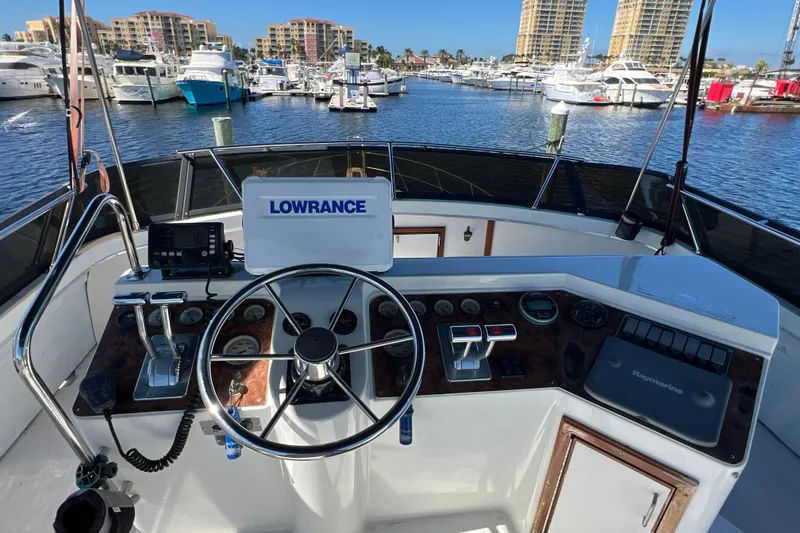 Slide: The Image of Cockpit view of 1987 Carver 4227 Motor Yacht with navigation equipment in marina setting. - 87