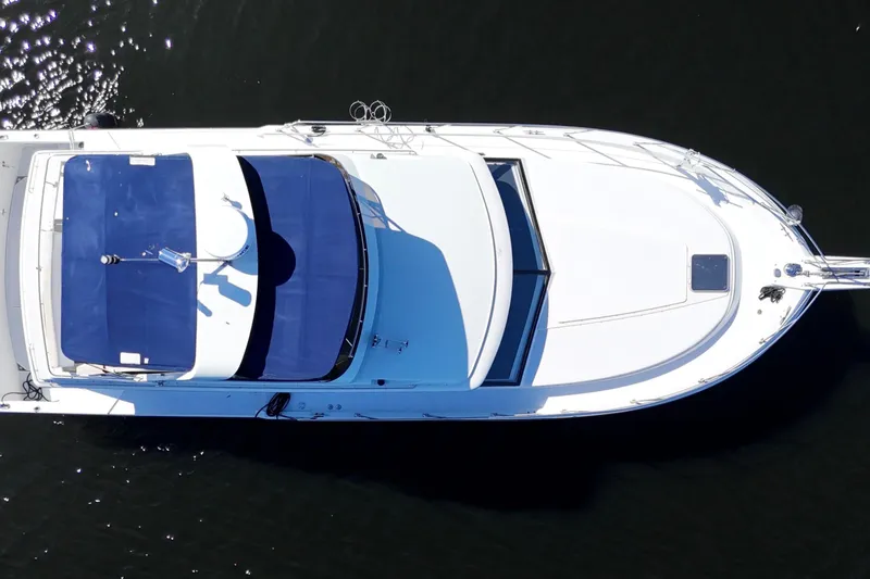 Slide: The Image of Top view of 1987 Carver 4227 Cockpit Motor Yacht on water. - 9