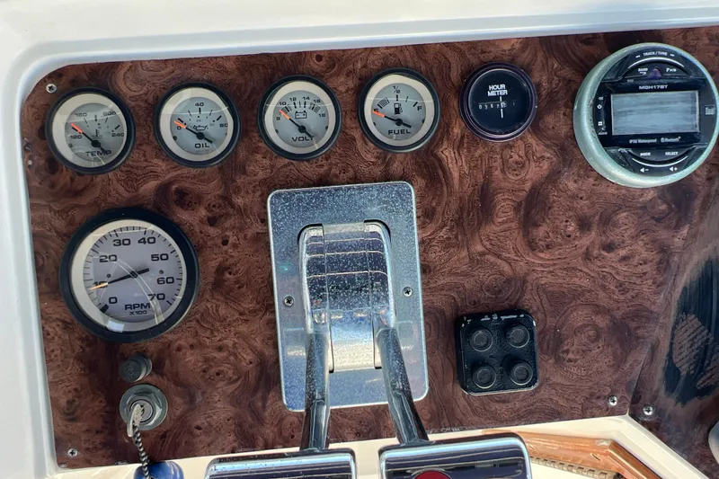 Slide: The Image of Dashboard of a 1987 Carver 4227 Cockpit Motor Yacht with gauges and controls. - 90