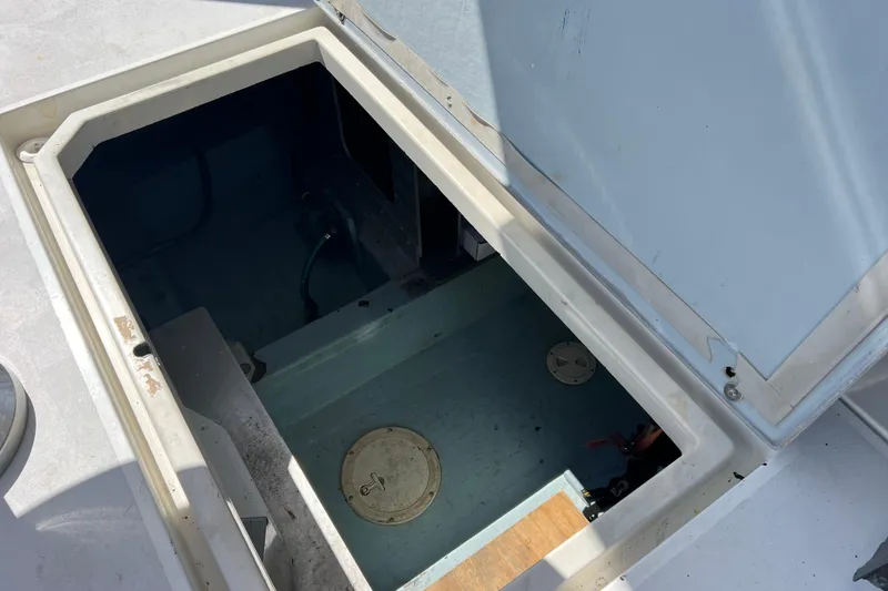 Slide: The Image of Open hatch on 1987 Carver 4227 Cockpit Motor Yacht, revealing storage compartment. - 97