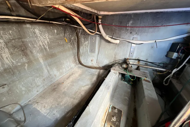 Slide: The Image of 1987 Carver 4227 Cockpit Motor Yacht interior wiring and structural components. - 99