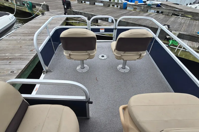 Slide: The Image of 2019 TRACKER MARINE Bass Buggy pontoon boat interior with seating at dock. - 8