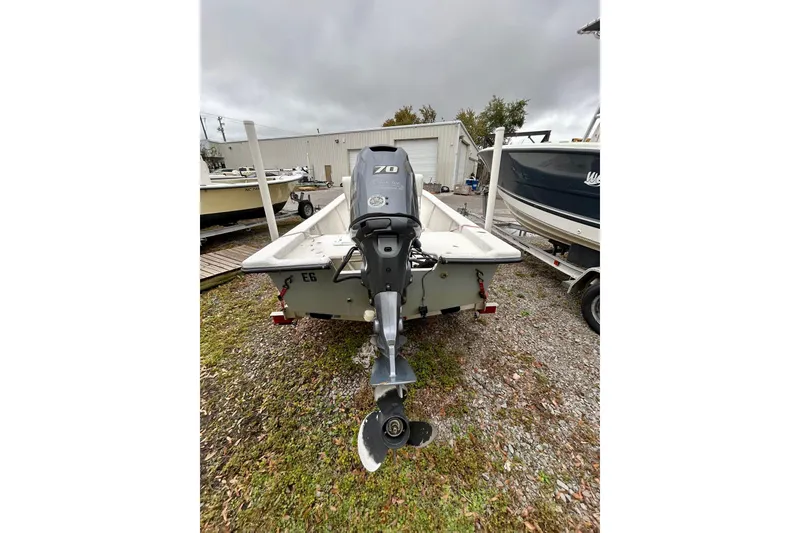 Slide: The Image of 2021 May-Craft 1700CC boat with outboard motor, parked on gravel near other boats. - 4