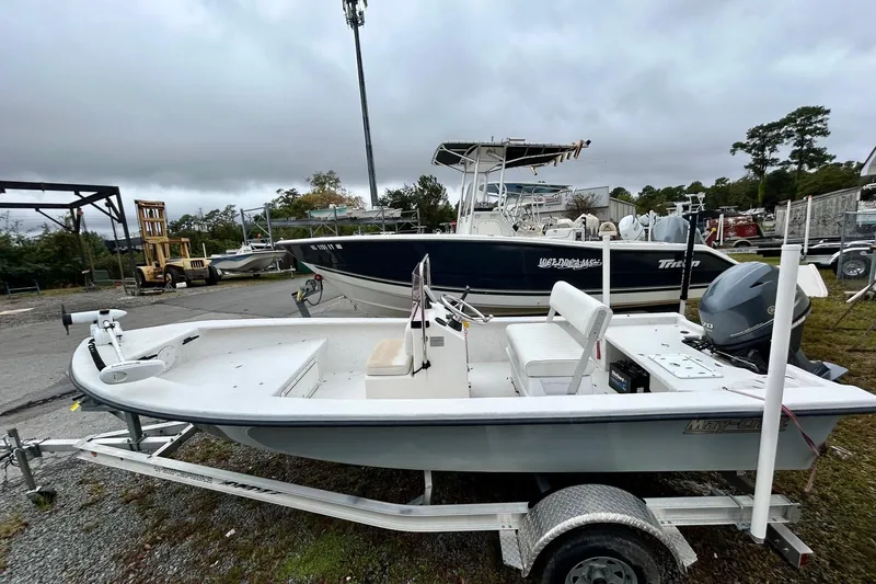 Slide: The Image of 2021 May-Craft 1700CC boat on trailer, parked outdoors under cloudy sky. - 6