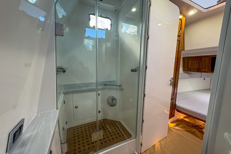 Slide: The Image of Luxurious interior of 2024 HCB 53 Sueños yacht featuring a modern shower and cozy cabin. - 17
