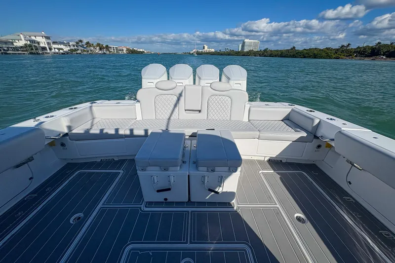 Slide: The Image of 2024 HCB 53 Sueños boat interior with spacious seating and scenic water view. - 55