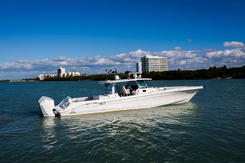 Slide: The Image of 2024 HCB 53 Sueños boat on calm water with cityscape background. - 9