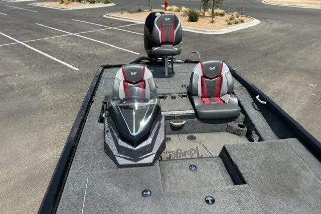 Slide: The Image of 2025 Ranger ALPHA 208 boat interior with modern seating and sleek design in a parking lot. - 24