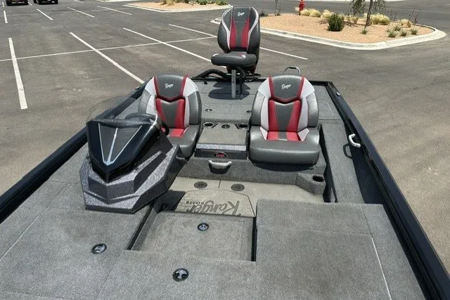 Slide: The Image of 2025 Ranger ALPHA 208 boat interior with sleek seating and modern design in a parking lot. - 18