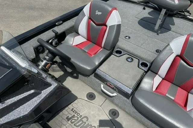 Slide: The Image of 2025 Ranger ALPHA 208 boat interior with red and gray seating, steering wheel, and storage compartments. - 21