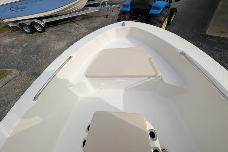 Slide: The Image of 2026 Robalo R160 Center Console boat interior with cushioned seating and stainless steel rails. - 4