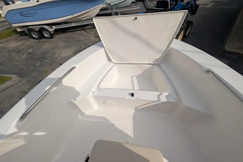 Slide: The Image of 2026 Robalo R160 Center Console boat interior with open storage compartment. - 5