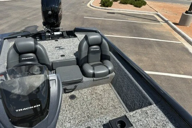 Slide: The Image of 2026 Tracker Pro Team 175 boat interior with gray seating and carpeted deck. - 16