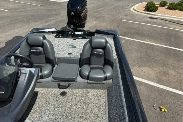 Slide: The Image of 2026 Tracker Pro Team 175 boat with dual seats in a parking lot. - 13