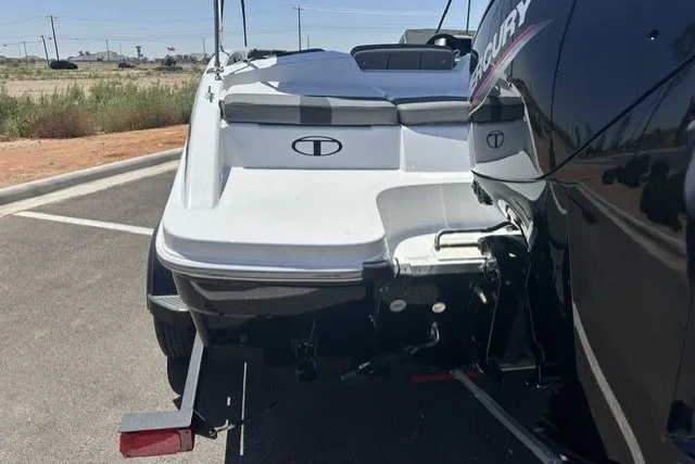 Slide: The Image of 2025 Tahoe T16 boat with Mercury engine, parked on asphalt, rear view. - 4