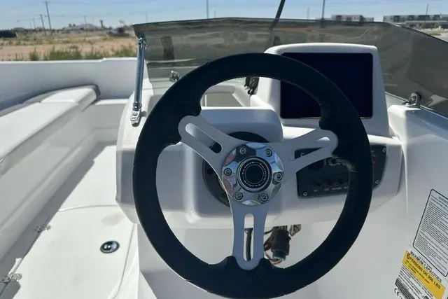 Slide: The Image of Steering wheel of 2025 Tahoe T16 boat, featuring modern dashboard and controls. - 8