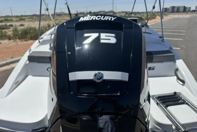 Slide: The Image of 2025 Tahoe T16 boat with Mercury 75 engine, parked outdoors. - 5