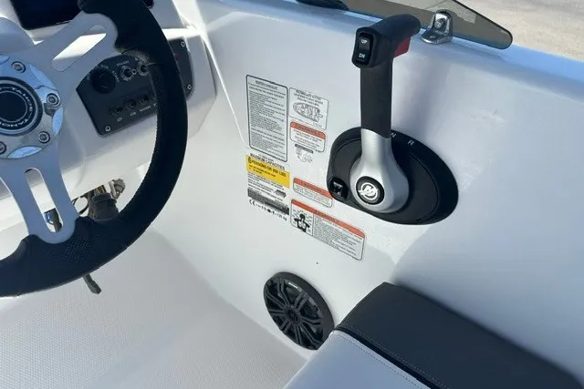 Slide: The Image of 2025 Tahoe T16 boat cockpit with steering wheel, throttle control, and safety instructions. - 9